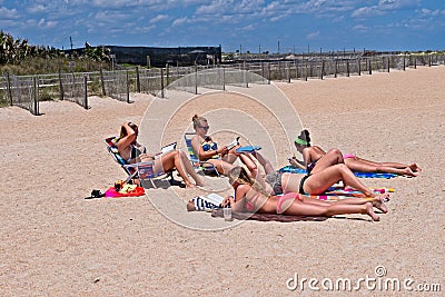 A group of teenage girls lay on the beach Editorial Stock Photo