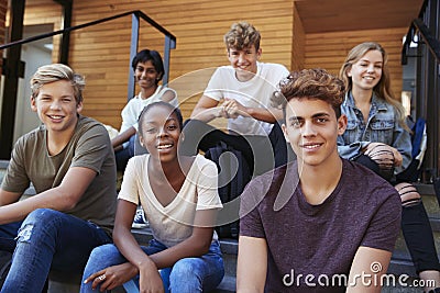 Group Of Teenage Students Socialising On College Campus Together Stock Photo