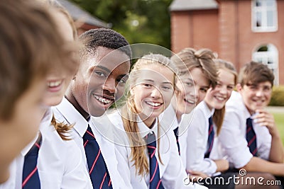 Group Of Teenage Students In Uniform Outside School Buildings Stock Photo