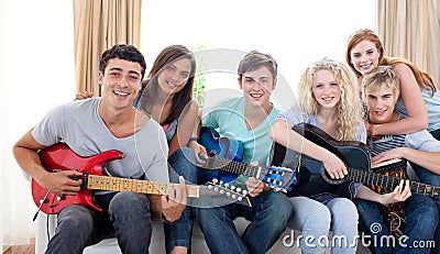 Group of teenagers playing guitar at home Stock Photo