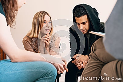 Group of teenagers sitting together and smiling during a support Stock Photo