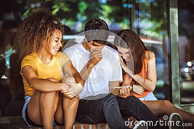 Group of teenagers on the street with CellPhones Stock Photo