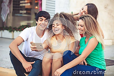 Group of teenagers on the street with CellPhones Stock Photo