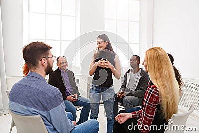 Therapist talking with a group at therapy session Stock Photo