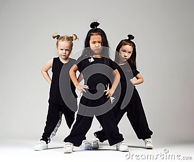 Group of three young girl kids hip hop dancers on gray Stock Photo