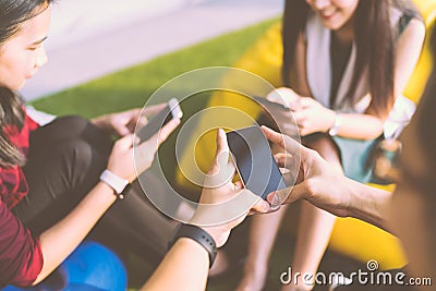 Group of three young people using smartphones together, modern lifestyle or communication technology gadget concept Stock Photo