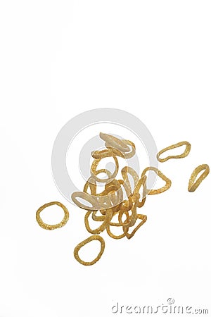 Group of Tiny Thin Flying Dried Onion Rings in Free Falling. isolated Over White Background Stock Photo