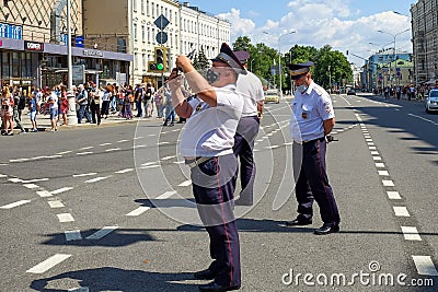 Group of tired policemen in summer uniforms and protective masks patrol city streets during global pandemic. Editorial Stock Photo