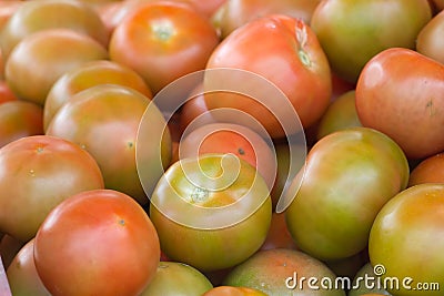 Group of tomatoes in market place. Red round ripe background. Ketchup production Stock Photo