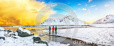 Group of tourist looking fabulous winter scenery on Skagsanden beach with illuminated clouds during sunrise Editorial Stock Photo