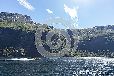 A group of tourist sitting in a jet boat on a sunny day in a river to enjoy mountain scenery Stock Photo