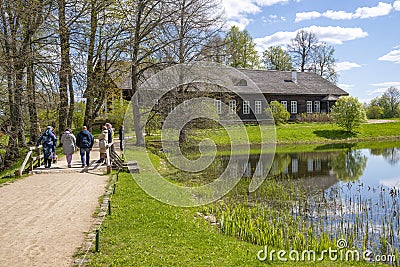 A group of tourists at the estate of the landowners Osipov-Wolf, Trigorskoye. Pushkin Mountains Editorial Stock Photo