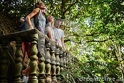 Group of tourists exploring ancient jungle ruins in thailand Stock Photo