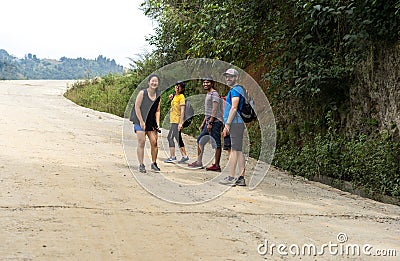A group of tourists hiking in Asian villages among paddy fields in Nepal Editorial Stock Photo