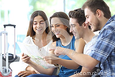 Group of tourists planning vacation checking maps Stock Photo