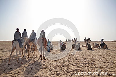 Group of tourists riding camels, Sahara Editorial Stock Photo