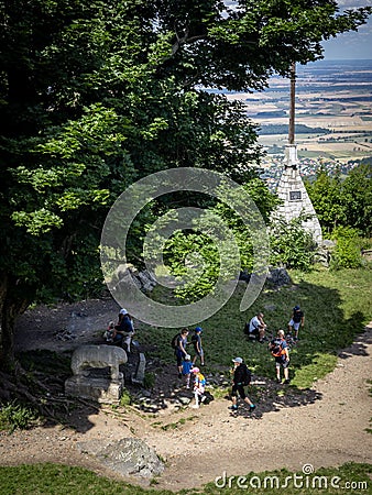 A group of tourists visiting the prehistoric sculpture of a stone bear, on the top of Sleza mountain, Poland. Editorial Stock Photo