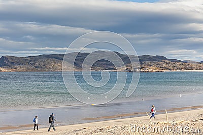 Group of tourists walking along the coast of the Barents Sea Editorial Stock Photo