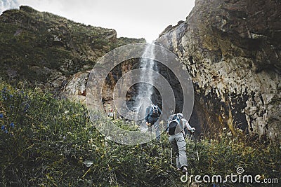 Group Of tourists Walking Uphill To Waterfall. Travel Adventure Outdoor Concept Stock Photo