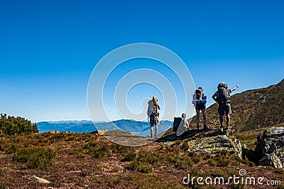 Group of trekkers hikers with backpacks looking at Maramures ridge from Rodna Mountains, Muntii Rodnei National Park, Romania, Stock Photo