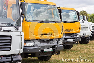 Group of trucks parked on the grass. Stock Photo