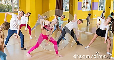 Tweens exercising with coach in choreography class Stock Photo