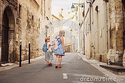 Group of two kids walking on the streets of old european town Stock Photo