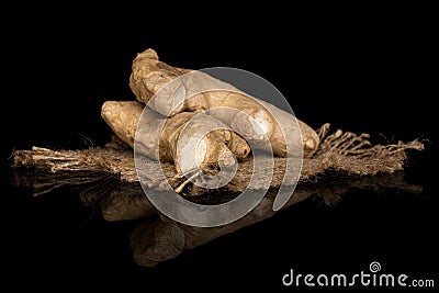 Fresh brown ginger isolated on black glass Stock Photo