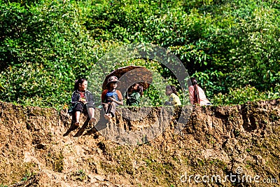 A group of unidentified ethnic children sitting on top of a mountain Editorial Stock Photo