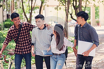 Group of university students walking outside together in campus, Happy Diverse students team concept. Stock Photo