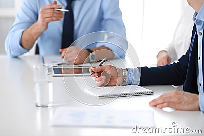 Group of unknown business people discussing questions at meeting in modern office, close-up of hands. Managers at Stock Photo