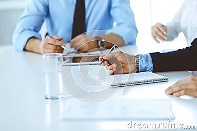 Group of unknown business people discussing questions at meeting in modern office, close-up of hands. Managers at Stock Photo