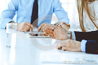 Group of unknown business people discussing questions at meeting in modern office, close-up of hands. Managers at Stock Photo