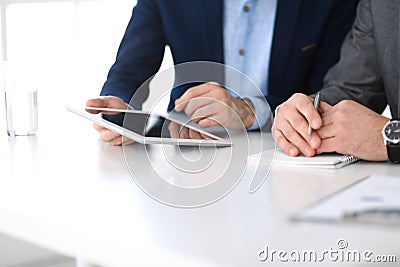 Group of unknown business people discussing questions at meeting in modern office, close-up of hands. Managers at Stock Photo