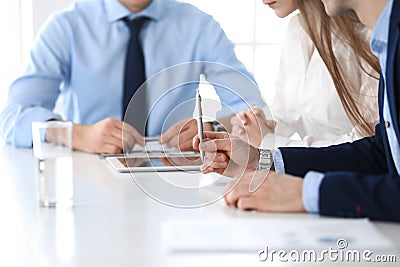 Group of unknown business people discussing questions at meeting in modern office, close-up of hands. Managers at Stock Photo