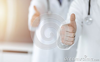 Group of unknown doctors standing as a team with thumbs up or Ok sign in hospital office, close-up. Medical help Stock Photo