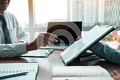 Group of usiness partnership coworkers working to chart company financial statements report and profits work progress and planning Stock Photo