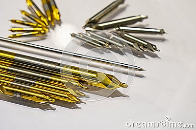 The group of various size of center drill on the white floor. Stock Photo