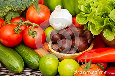 Group vegetables and Fruits Apples, grapes, oranges, pineapples, bananas in a wooden basket with carrots, tomatoes, guava, chili, Stock Photo