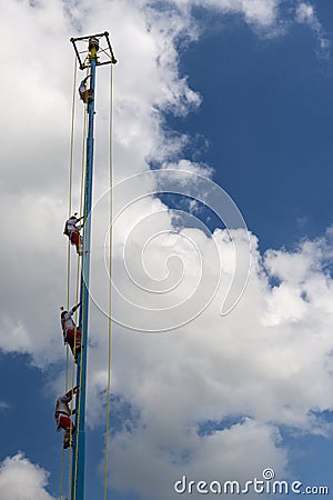 A group of voladores flyers climbing the pole to perform the traditional Danza de los Voladores Dance of the Flyers in Papantl Editorial Stock Photo