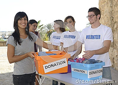 Group of volunteers collecting clothing donations Stock Photo