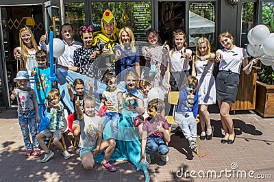 Group of volunteers and entertainers with happy kids during children protection day Editorial Stock Photo