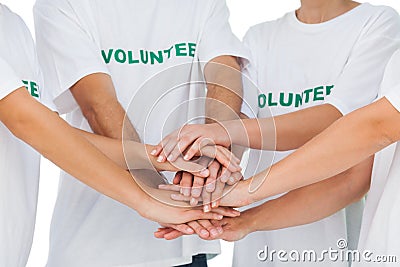 Group of volunteers putting hands together Stock Photo