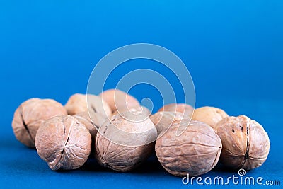 group of wallnuts is on a blue background, healthy food concept Stock Photo