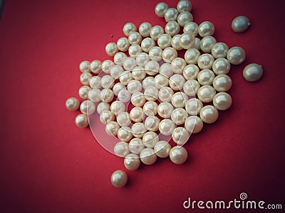 A group of golden and white pearls on brown background,costly,Golden and white glass bead Stock Photo