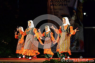 Turkish women dancing with wooden spoons at folklore festival stage Editorial Stock Photo