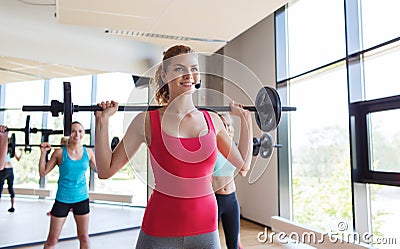 Group of women excercising with bars in gym Stock Photo