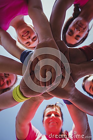 Group of women forming hand stack in the boot camp Stock Photo