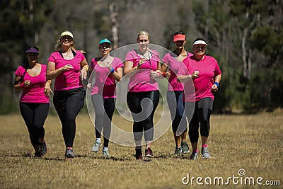 Group of women jogging together in the boot camp Stock Photo