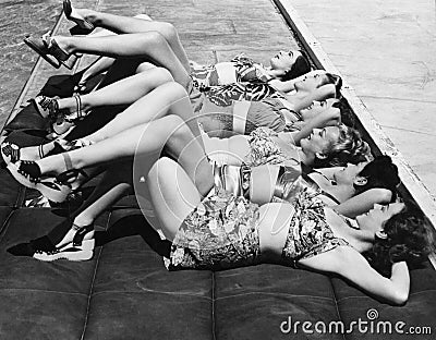 Group of women relaxing in a row together Stock Photo